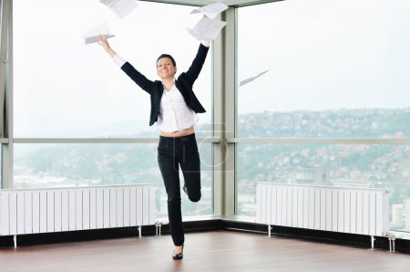 Young business woman throw papers in air