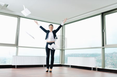 Young business woman throw papers in air