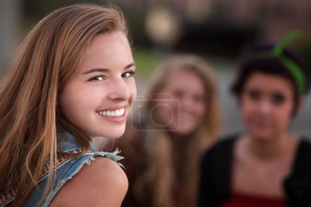 Smiling Teen Girl with Two Friends
