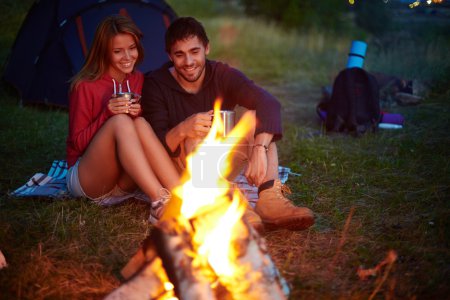 Young couple looking at fire