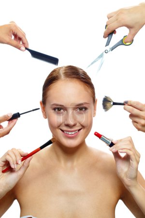 Female surrounded by hands with beauty tools