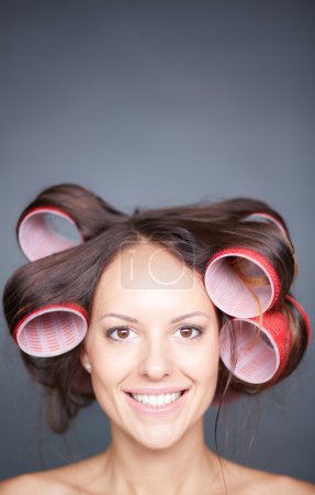 Woman with hair curlers