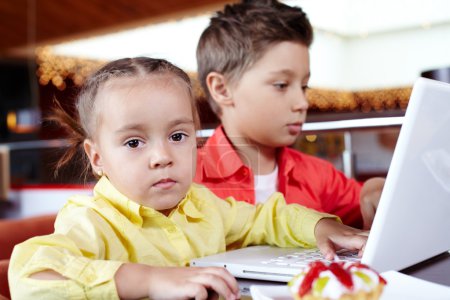 Children typing on laptop