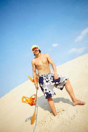 Young man sandboarding