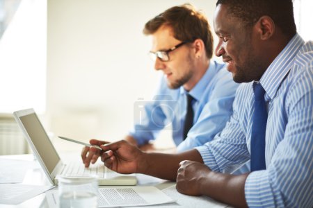 Businessmen using laptop