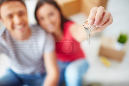 Woman showing key from new flat