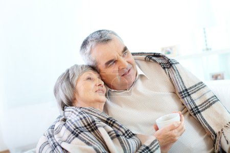 Pensioners having tea at home