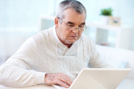 Pensioner using laptop