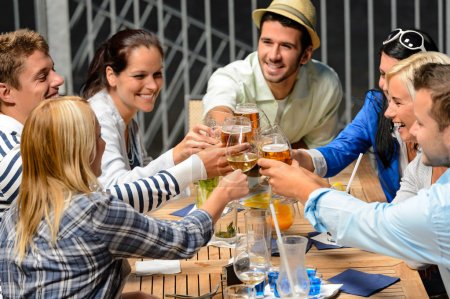 Group of cheerful toasting with drinks