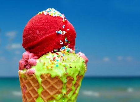tasty melting ice cream on summer background