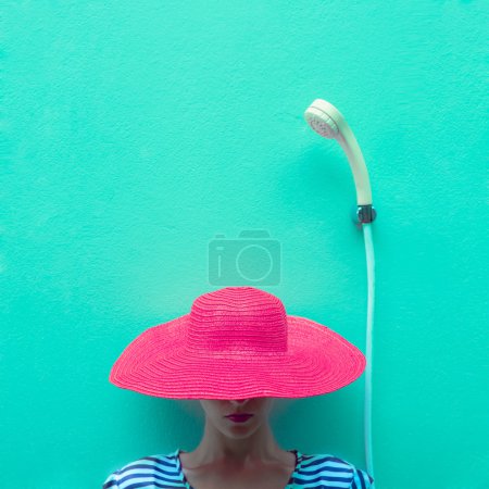portrait of a girl in a pink hat in the shower