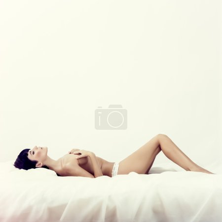 portrait of a beautiful sleeping girl in white bed