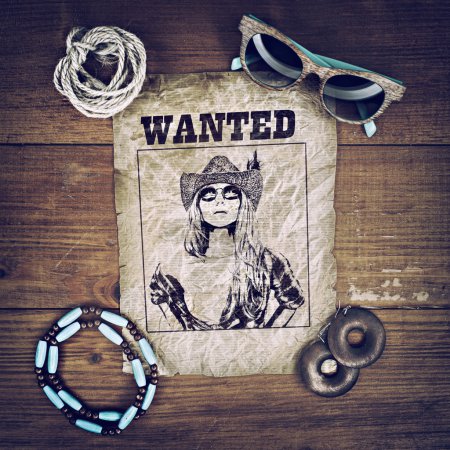 Accessories cowboy retro style on wooden background with wanted poster