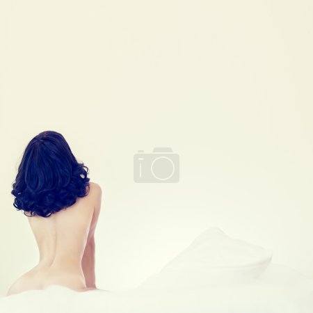 portrait of young sensual woman in white bed