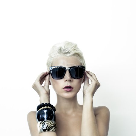 portrait of beautiful blond woman in fashionable glasses