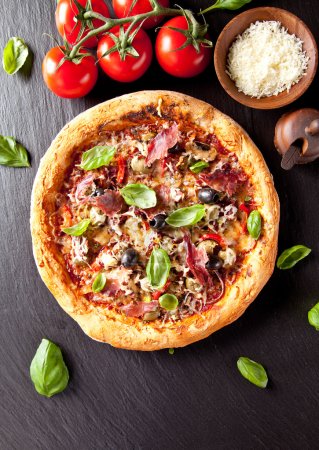 Fresh italian pizza served on black stone