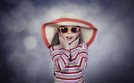 Happy summery girl wearing a hat and sunglasses