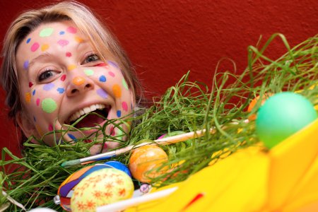 blonde young woman with colorful Easter eggs