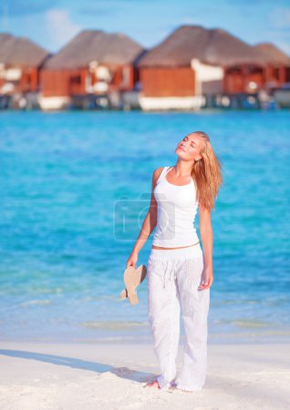 Pretty woman walking along beach