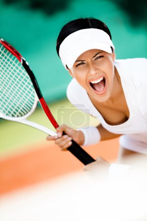 Sportswoman in sportswear playing tennis