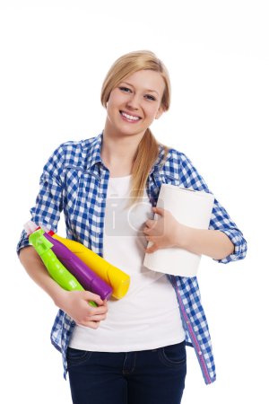 Happy blonde woman holding cleaning equipment