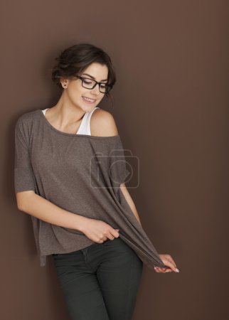 Woman posing on brown wall