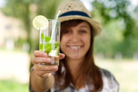 Young woman with mojito drink