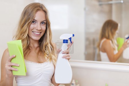 Woman is ready to cleaning bathroom