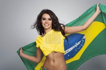 Girl waving flag of Brazil
