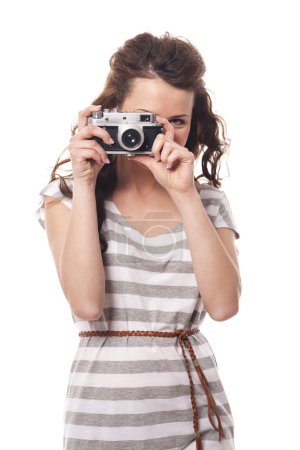 Woman taking photo by retro camera