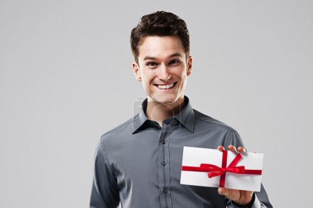 Happy man holding white card