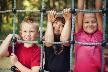 Happy children holding a net on playground