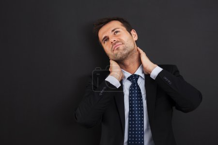 Businessman having pain in the neck
