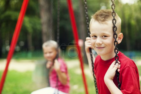 Children swinging together