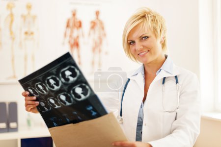Doctor opening envelope with brain tomography result