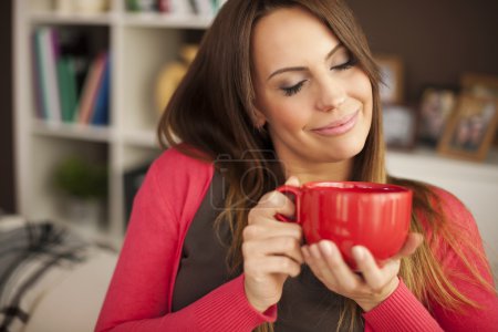 Woman enjoying the smell of coffee
