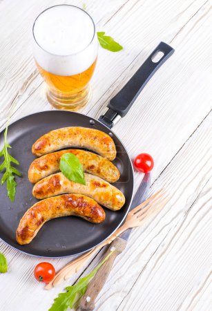 The Munich sausages with tomatoes and arugula
