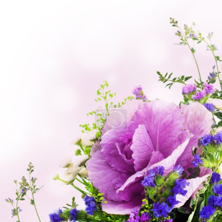 A spring decorative cabbage is in a bouquet, floral background