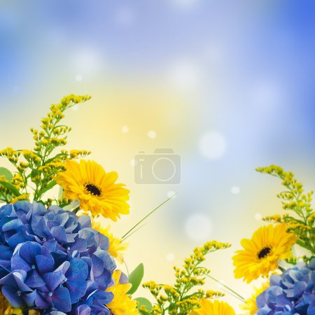 Bouquet from blue hydrangeas and yellow asters, a flower background