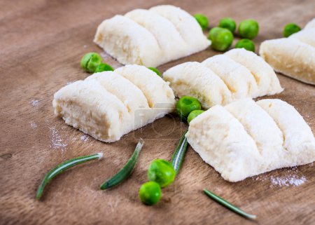 Cheese gnocchi with peas and rosemary