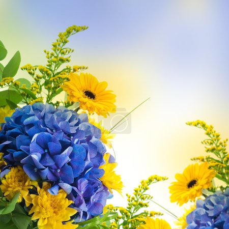 Bouquet from blue hydrangeas and yellow asters, a flower background