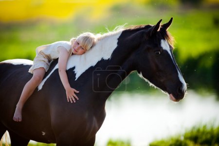 Child sits on a horse