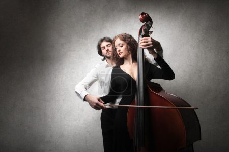 man, woman holding a double bass