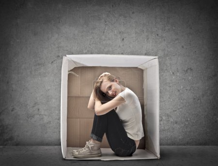 Smiling Blonde Girl Crouched in a Box