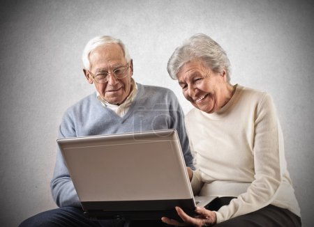 Old man and woman using a laptop