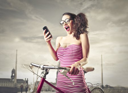 Excited woman looking at her mobile phone