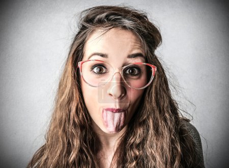 Young woman stucking out her tongue