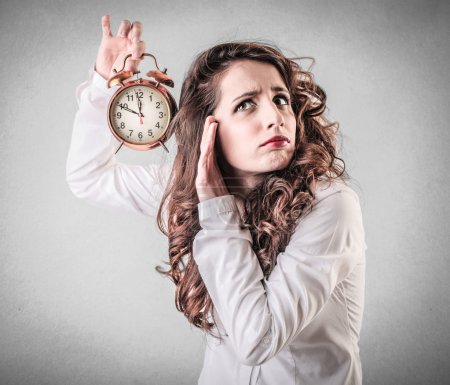 Woman holding an alarm clock