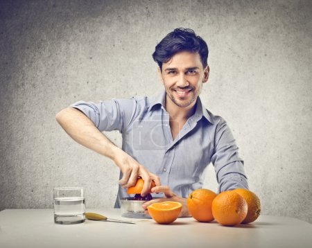 Man squeezing some oranges