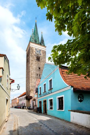 Telc, Czech Republic - May 10, 2013: Holy Spirit Lutheran Church and restaurant in blue colour in Telc, Unesco city